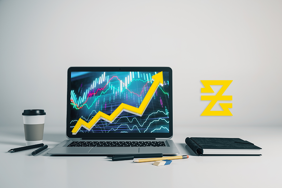 laptop display with forex trading platform and yellow trend line up next to baxia symbol