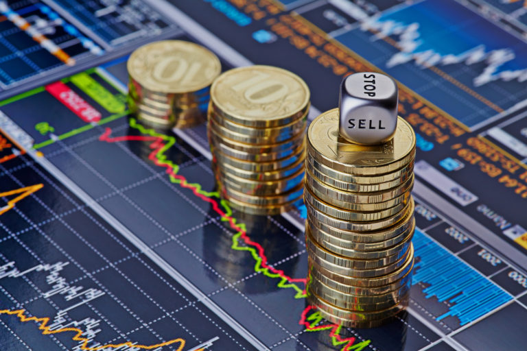 forex supply and demand concepts shown with uptrend stacks of golden coins and the dices cube